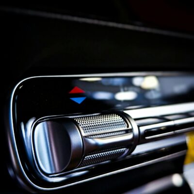 Detailed view of a car's air conditioning control knob and panel, emphasizing modern design.